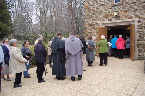 Photo of people entering church